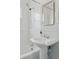 Stylish bathroom showcasing a pedestal sink, tub-shower combo, and modern fixtures at 3740 W 54Th Ave, Denver, CO 80221
