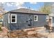 Exterior view of the home showcasing the siding, windows, and garden beds at 3740 W 54Th Ave, Denver, CO 80221