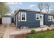 View of the home's side and backyard, showcasing the clean lines and a detached garage at 3740 W 54Th Ave, Denver, CO 80221