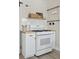 Kitchen with white cabinetry, white appliances, and butcher block countertops at 3740 W 54Th Ave, Denver, CO 80221
