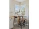 Cozy breakfast nook with a small table, stools, and a large window bringing in natural light at 3740 W 54Th Ave, Denver, CO 80221
