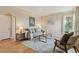 Cozy living room featuring hardwood floors, neutral walls, and stylish, comfortable furniture at 3740 W 54Th Ave, Denver, CO 80221