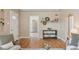 Open living space with hardwood floors, a decorative shelf, and a view into the adjacent kitchen at 3740 W 54Th Ave, Denver, CO 80221