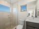 Contemporary bathroom with a glass-enclosed shower, stylish fixtures, and a light-filled window at 845 Eudora St, Denver, CO 80220