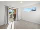 Bright bedroom with glass sliding doors, neutral carpet, and a single window at 845 Eudora St, Denver, CO 80220