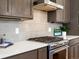 Kitchen gas range featuring stainless steel appliances, quartz countertops, tile backsplash and modern cabinets at 845 Eudora St, Denver, CO 80220