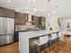 Modern kitchen with stainless steel appliances, quartz countertops and island with barstool seating at 845 Eudora St, Denver, CO 80220