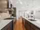 Gorgeous kitchen featuring stainless appliances, quartz countertops, gas range, and an island with sink at 845 Eudora St, Denver, CO 80220