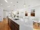 Open kitchen featuring stainless appliances, quartz countertops and views into the dining and living rooms at 845 Eudora St, Denver, CO 80220