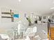 Bright open-concept living room featuring a dining area with a glass table and white chairs at 845 Eudora St, Denver, CO 80220