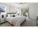 Bright main bedroom features a ceiling fan, sliding glass doors, and neutral decor at 845 Eudora St, Denver, CO 80220