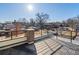 Spacious rooftop deck with black metal railings offering city views under a sunny sky at 845 Eudora St, Denver, CO 80220