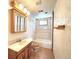A bright bathroom featuring white tiles in the shower, and a wood vanity at 1716 Virginia St, Idaho Springs, CO 80452