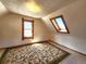 Upstairs bedroom with angled walls, unique window shape, and neutral carpet at 1716 Virginia St, Idaho Springs, CO 80452