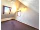 Upper level bedroom offers unique window shapes, a ceiling fan, and neutral carpet at 1716 Virginia St, Idaho Springs, CO 80452