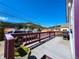 Expansive deck offering scenic views of the town and surrounding hills, framed by a distinctive purple railing at 1716 Virginia St, Idaho Springs, CO 80452