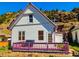 Charming home with a well-maintained exterior, bright purple trim and stone foundation at 1716 Virginia St, Idaho Springs, CO 80452
