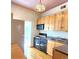 Kitchen featuring light wood cabinets, black appliances and durable countertops at 1716 Virginia St, Idaho Springs, CO 80452