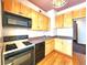 Efficient kitchen layout with black appliances, wood cabinets and an ample countertop at 1716 Virginia St, Idaho Springs, CO 80452