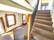 Carpeted staircase with metal railing and natural wood trim leads to the upper level at 1716 Virginia St, Idaho Springs, CO 80452
