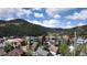 Panoramic view of a mountain town under a blue sky with fluffy white clouds at 1716 Virginia St, Idaho Springs, CO 80452