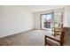 Bright living room featuring neutral carpet, sliding glass doors, and a pair of cozy armchairs at 2715 W 86Th Ave # 21, Westminster, CO 80031