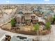 An aerial view of the neighborhood with this home having a big backyard with nice landscaping at 8044 E 24Th Ave, Denver, CO 80238