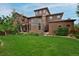 Expansive backyard features lush greenery, a manicured lawn, and a stunning view of the home at 8044 E 24Th Ave, Denver, CO 80238