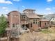 A beautiful backyard with mature trees and detailed deck areas at 8044 E 24Th Ave, Denver, CO 80238