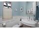 Powder room with blue paint, white wainscoting, and pedestal sink at 8044 E 24Th Ave, Denver, CO 80238