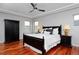 Bedroom with dark wood furnishings, tray ceilings, and hardwood floors at 8044 E 24Th Ave, Denver, CO 80238