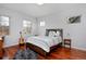Bright bedroom featuring a guitar, hardwood floors, lots of windows, and modern decor at 8044 E 24Th Ave, Denver, CO 80238