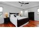 Bedroom with dark wood furnishings, tray ceilings, and hardwood floors at 8044 E 24Th Ave, Denver, CO 80238