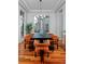 Elegant dining room features modern chandelier, large window, and seating for six at 8044 E 24Th Ave, Denver, CO 80238