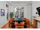 Elegant dining room features modern chandelier, large window, and seating for six at 8044 E 24Th Ave, Denver, CO 80238
