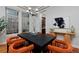 Elegant dining room features modern chandelier, large windows, and seating for six at 8044 E 24Th Ave, Denver, CO 80238