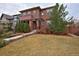 Charming two-story home with a brick and stucco facade and a well-manicured front yard at 8044 E 24Th Ave, Denver, CO 80238