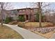 Charming two-story home with a brick and stucco facade and a landscaped front yard with a sidewalk at 8044 E 24Th Ave, Denver, CO 80238