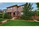 Charming two-story home with landscaped front yard, walkway, and inviting covered entryway at 8044 E 24Th Ave, Denver, CO 80238