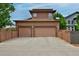A modern two car garage featuring brown doors and decorative lighting at 8044 E 24Th Ave, Denver, CO 80238