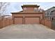 A two-car garage with a concrete driveway and an enclosed fence at 8044 E 24Th Ave, Denver, CO 80238