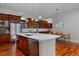 Spacious kitchen with stainless steel appliances, island with counter seating and modern fixtures at 8044 E 24Th Ave, Denver, CO 80238