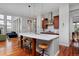 Open kitchen with large island, pendant lighting, stainless appliances, and hardwood flooring at 8044 E 24Th Ave, Denver, CO 80238