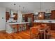Spacious kitchen with stainless steel appliances, white countertops, an island and wooden cabinets at 8044 E 24Th Ave, Denver, CO 80238