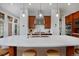 Modern kitchen with sleek countertops, stainless steel appliances, white backsplash, and stylish pendant lighting at 8044 E 24Th Ave, Denver, CO 80238