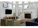 Bright living room with fireplace, many windows and hardwood flooring at 8044 E 24Th Ave, Denver, CO 80238