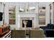 Bright living room with fireplace, many windows and hardwood flooring at 8044 E 24Th Ave, Denver, CO 80238