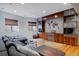 Modern living room features a large gray sectional, custom wood shelving, and a unique world-map accent wall at 8044 E 24Th Ave, Denver, CO 80238