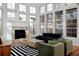 Bright living room with fireplace, many windows and hardwood flooring at 8044 E 24Th Ave, Denver, CO 80238