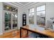Bright office space with hardwood floors, large windows, and glass doors to outdoor area at 8044 E 24Th Ave, Denver, CO 80238